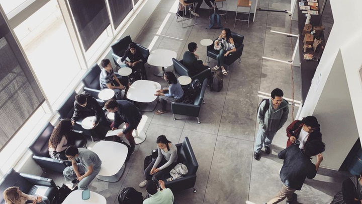 A view of the student lounge area, filled with med students, overlooking the Geffen Hall courtyard